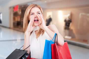 Young shopping woman with colored gift bags