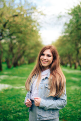 Beautiful woman in a summer park in sunny weather