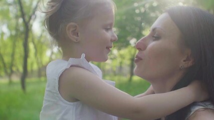 Mom and daughter are walking in the park - Powered by Adobe