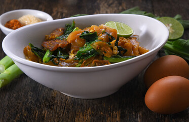 Fried thin noodles with soy sauce in white dish
