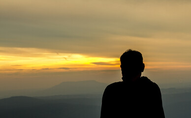 silhouette of people on top of mountain
