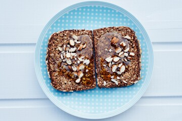 Whole grain bread sandwich with honey and almonds