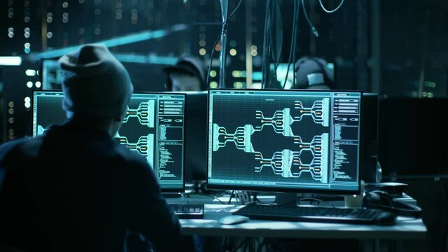 Team of Internationally Wanted Hackers Teem Organize Advanced Malware Attack on Corporate Servers. Place is Dark and Has Multiple displays.Shot on RED EPIC-W 8K Helium Cinema Camera.