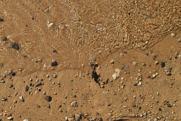 Fototapeta na wymiar Shore. Shoreline. Sand. Color sand. Wave. water