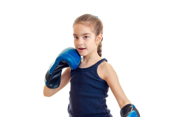 baby-girl standing in boxing gloves and looks toward isolated on a white background