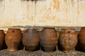 Fototapeta premium Huge old ceramic pots in a monastery in Chania region on Crete island, Greece.