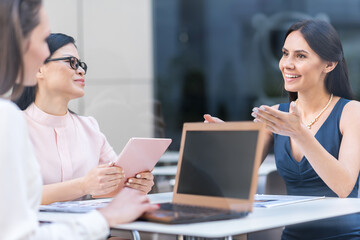 Cheerful girls speaking in cafe