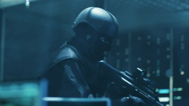 Special Forces Armed Soldier Enters Hacker's Secret Hideout, He's Ready To Shoot. He Searches the Place and Sees Multiple Working Displays, Cables. Shot on RED EPIC-W 8K Helium Cinema Camera.