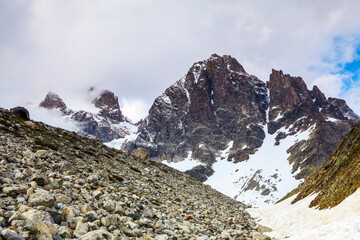 The tops of rugged mountains in the fog.