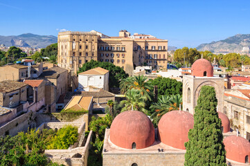 The famous red domes of the Church of St. John of the Hermits San Giovanni degli Eremiti and the Norman Palace Palazzo dei Normanni - Palermo, Sicily, Italy