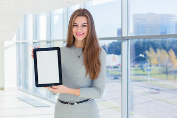 Fototapeta premium Businesswoman holds a tablet in his hands at the office