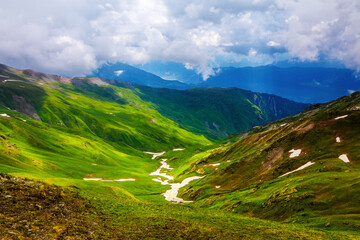 Landscape with picturesque meadows and mountains.