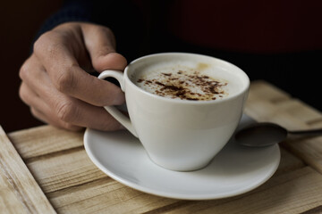 young man with a cup of cappuccino