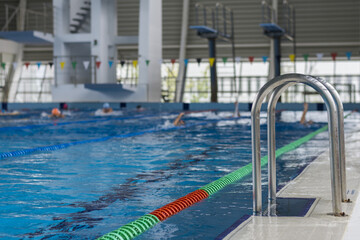 Detail from swimming competition pool during training. Covered pool. Olympic size.