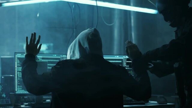 Fully Armed Special Cybersecurity Forces Soldier Arrests  and Handcuffs Highly Dangerous Hacker. Hideout is Dark and Full of Computer Equipment. Shot on RED EPIC-W 8K Helium Cinema Camera.