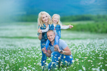 Fototapeta premium happy family having fun outdoors. Portrait of happy family in countryside Happy people outdoors wearing jeans enjoying time together