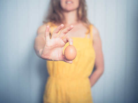 Young woman holding an egg