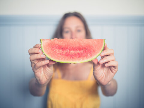Young woman with slice of watermelon