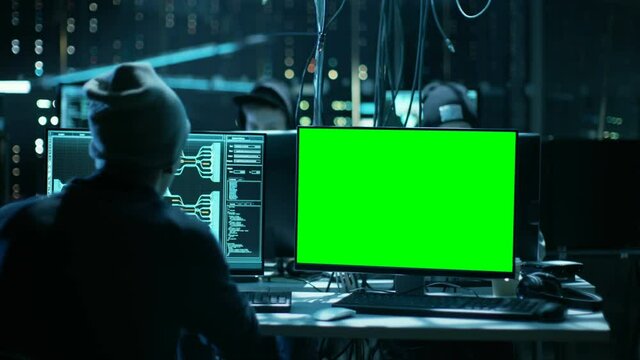 Team of Internationally Wanted Teenage Hackers with Green Screen Mock-up Display Infect Servers and Infrastructure with Malware. Shot on RED EPIC-W 8K Helium Cinema Camera.