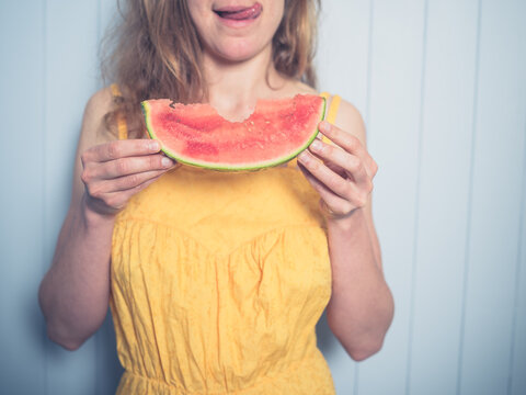 Young woman eating water melon
