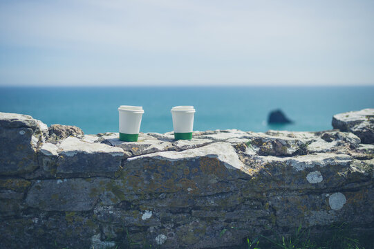 Two paper cups by the sea