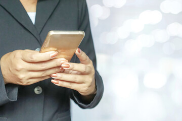 business woman in black suit using smart phone with white blur background 