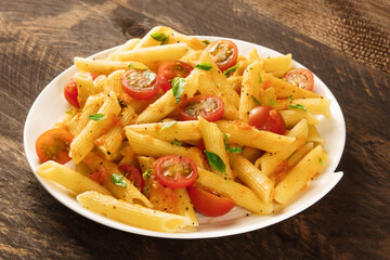 Penne pasta with tomato sauce and fresh basil leaves