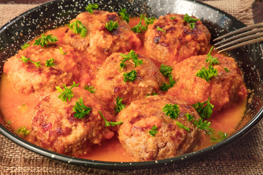 Closeup photo of meatballs in tomato sauce in skillet