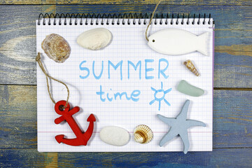 summer time concept. written in notebook with sea theme accessories