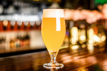 A glass of unfiltered beer on counter