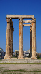 Fototapeta premium Photo of iconic pillars of Temple of Olympian Zeus with view to the Acropolis and the Parthenon, Athens historic center, Attica, Greece 