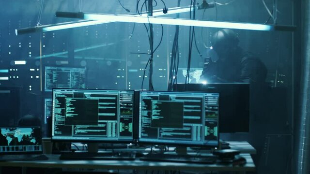 Special Forces Armed Soldier Searches Hacker's Secret Hideout, He's Ready To Shoot. He Searches the Place and Sees Multiple Working Displays, Cables. Shot on RED EPIC-W 8K Helium Cinema Camera.