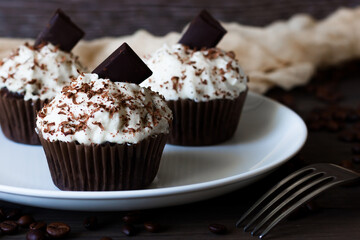 Chocolate-coffee cupcakes on a dark wooden background