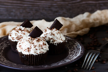 Chocolate-coffee cupcakes on a dark wooden background