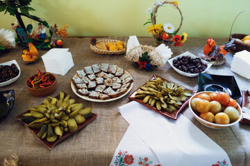Pickled vegetables, leaf lard and other snacks served on brown cloth