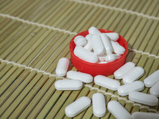 Group of white medicine tablets on table
