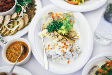 Look from above at plate with fish, mushrooms and greenery