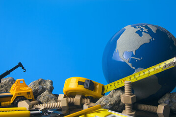 construction tools with globe on blue background