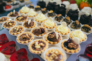 Baskets with chocolate cream and nuts served on mirror dish