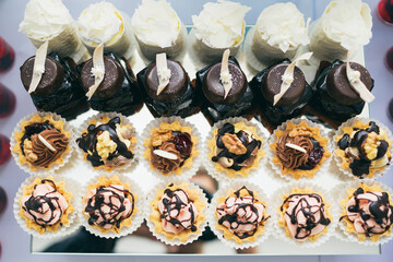 Baskets with chocolate cream and nuts served on mirror dish