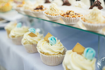 Cupcakes with white cream and blue roses