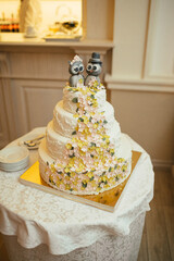 Figures of owls stand on the top of white wedding cake
