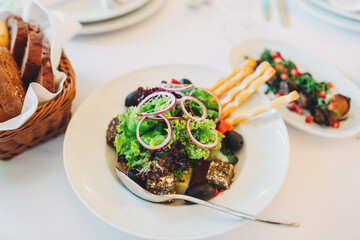 Plate with green salad and a spoon