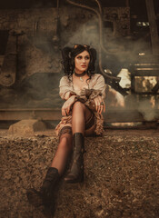 A girl in steampunk style sits near a retro train. The background is filled with smoke. Creative colors.