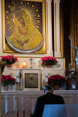 altar with St MAria and prying priest