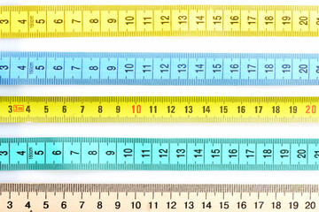 Rulers of different materials lying in parallel