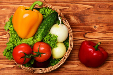 agricultural concept, vegetables, lettuce, tomatoes, onions, peppers, cucumber in basket