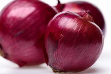 Composition made of red onions with dry peel in closeup