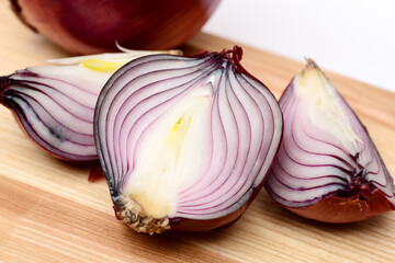 Half and quarters of red onion with whole purple vegetable