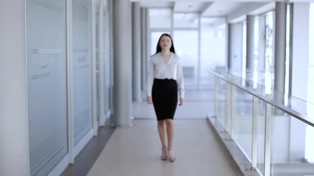 Attractive woman walking ,then stops and cross her arms while smiling